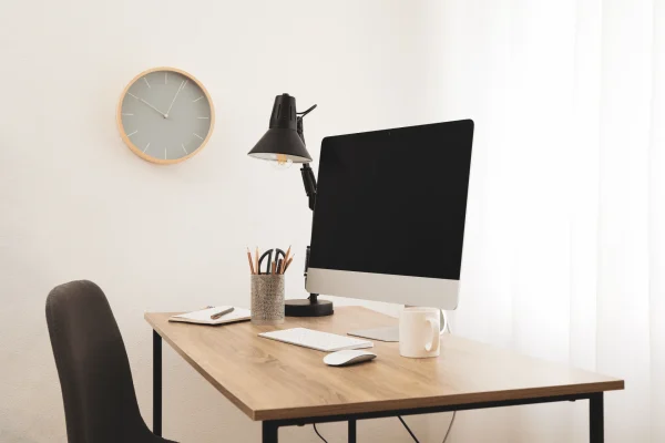 A minimalist desk has a monitor, keyboard, mouse, cup for pencils and pens, a little decorations.

Minimalist desk example, Envato